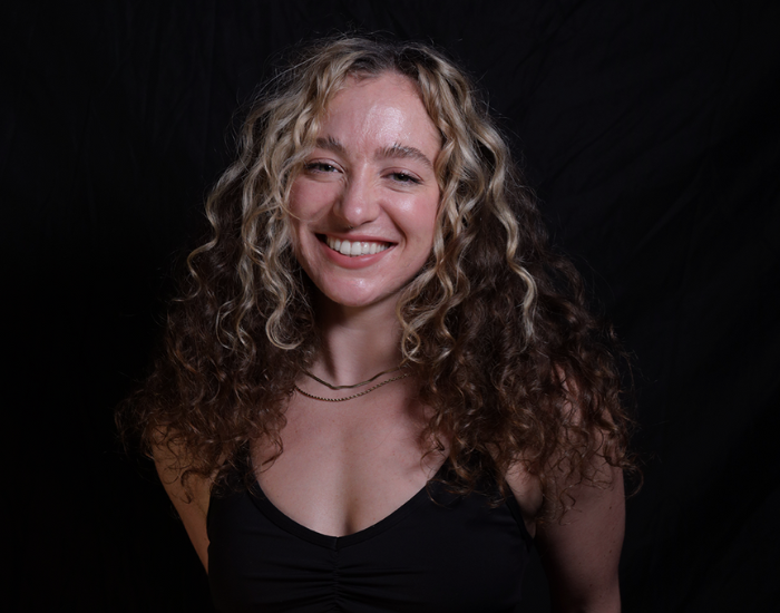 Psycle coach Queenie smiling against a black background